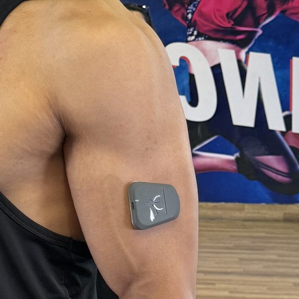 The Muscle Puck worn on an athlete's arm